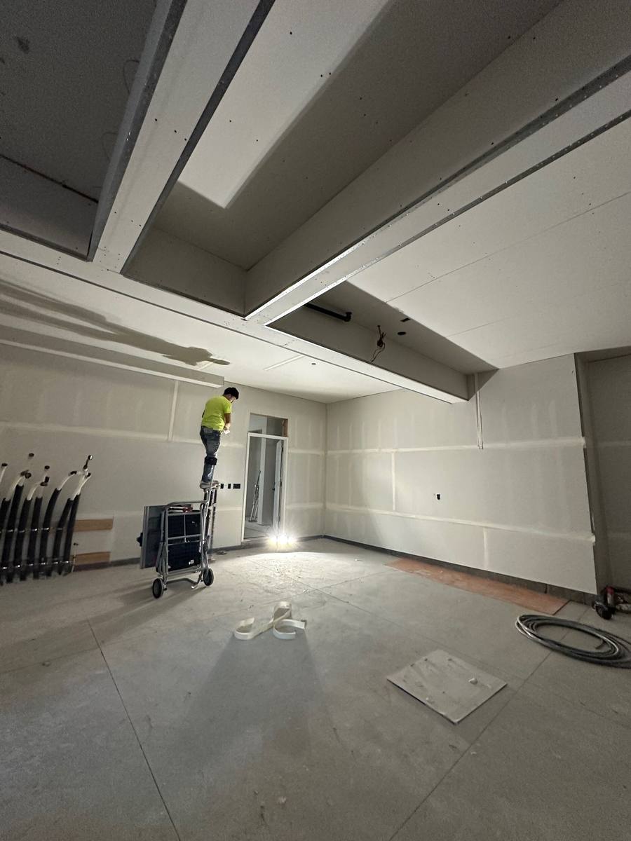 Strong Finish Drywall crew member taping and finishing drywall ceiling
